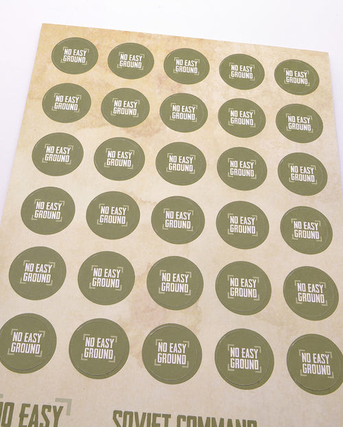 A sheet of round stickers with a beige background and olive green circles, 