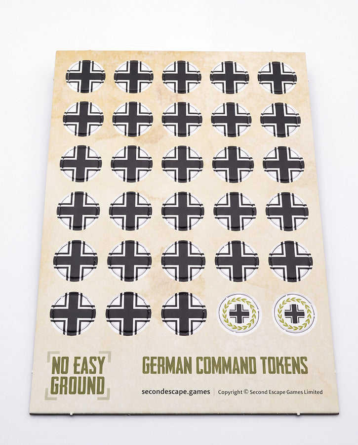 A sheet of vintage German Command Tokens for board games, featuring black and white iron crosses on a beige backing card with 'German Command Tokens' printed at the bottom.