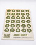 A printed card or sheet containing 30 olive green circular counters numbered 1 to 30, with the text 'NO EASY GROUND' and 'NUMBERED COUNTERS' on a light beige background.